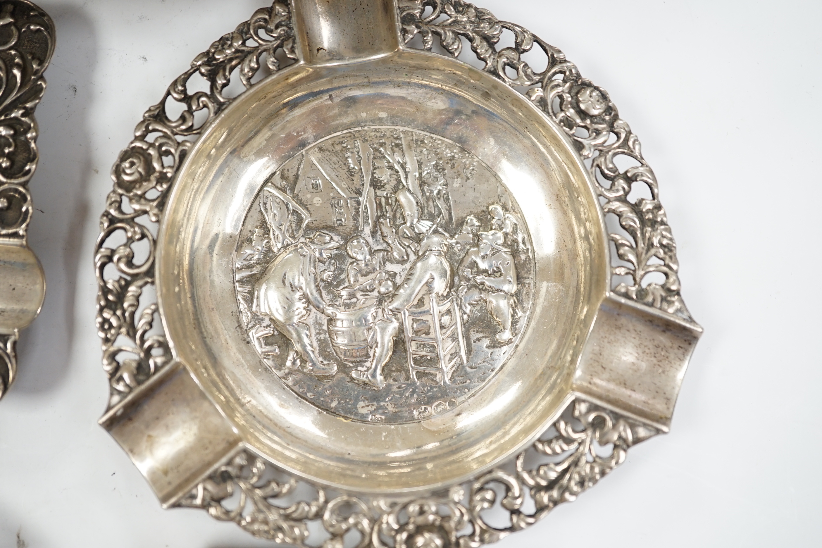 A German pierced 800 white metal oval dish, 28.4cm, three Dutch white metal ashtrays and an 835 white metal lighter.
